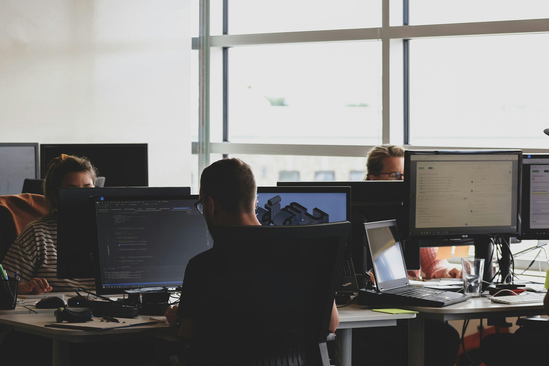 A platform content team working across monitors in an open-plan office