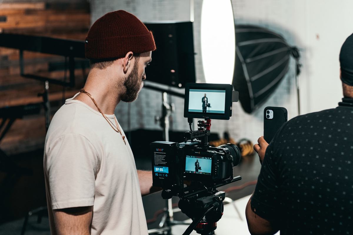 A production team member setting the framing for a presenter
