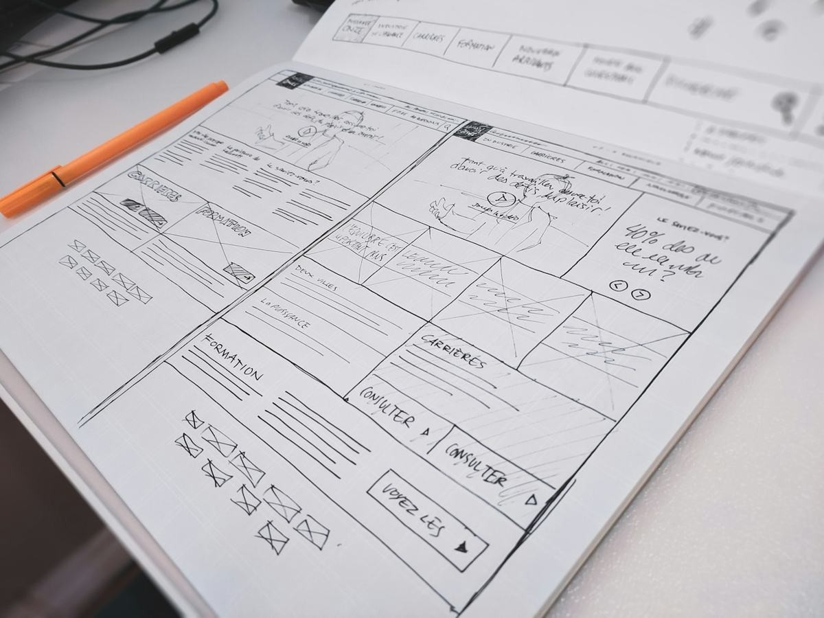 A hand-drawn storyboard on paper with a pen resting beside it